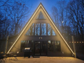 Modern A-frame in woods' embrace with a Hot Tub